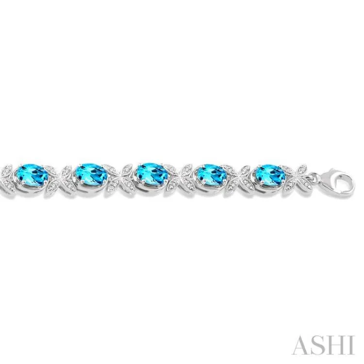 1/10 Ctw Round Cut Diamond & 7x5 MM Oval Cut Blue Topaz Semi Precious Bracelet in Sterling Silver